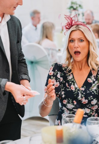 Wedding guest has shocked face as ben shows a card