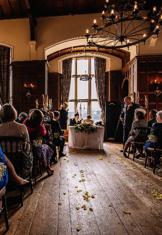Bride and groom sign the register at Chateau Rhianfa wedding venue, Anglesey, North Wales