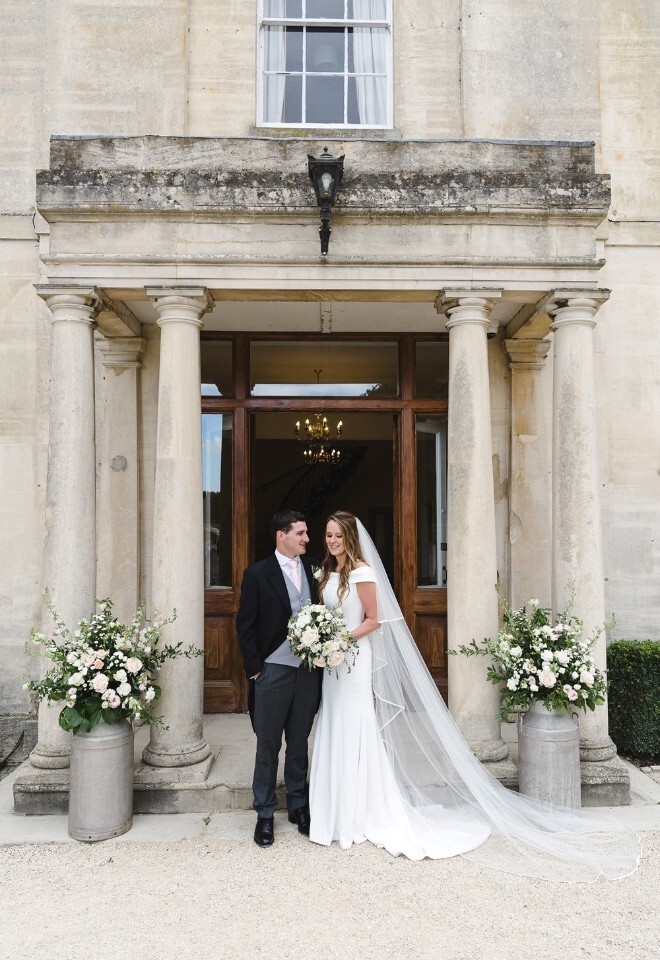 Newlyweds at the pillared entrance