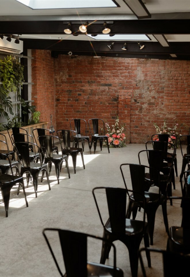 Ceremony space with plant wall and exposed brick