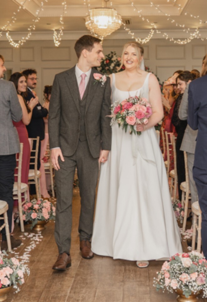 pink, red and white wedding ceremony indoors
