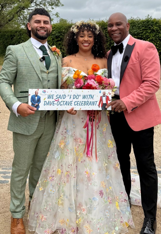 Dave Octave Celebrant with a happy bride and groom smiling and holding my We said I Do with Dave Octave Celebrant sign.