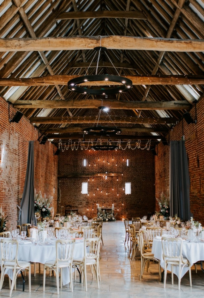 A beautiful wedding breakfast set up in the barn at Copdock Hall wedding venue Suffolk