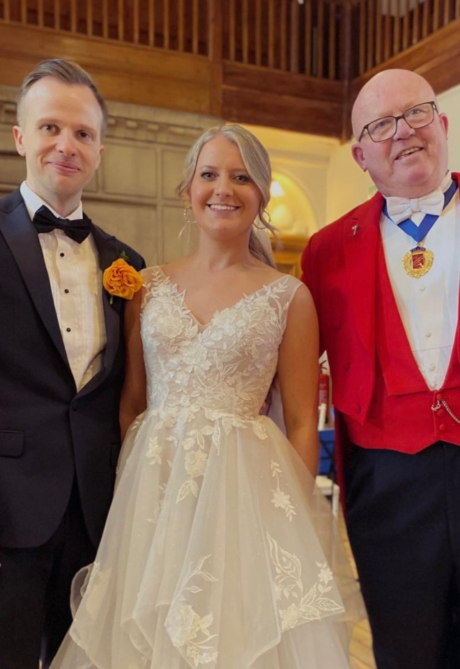 Surrey wedding toastmaster and celebrant Toastmaster John with a smiling bride and groom during their wedding celebrations.
