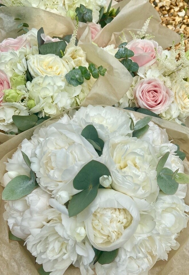 Perfect peony bridal bouquet with pink and white maids in the back. 