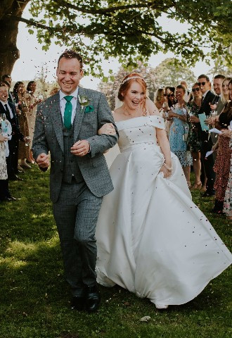 Bride and groom being showered in confetti at Howsham Hall, Yorkshire