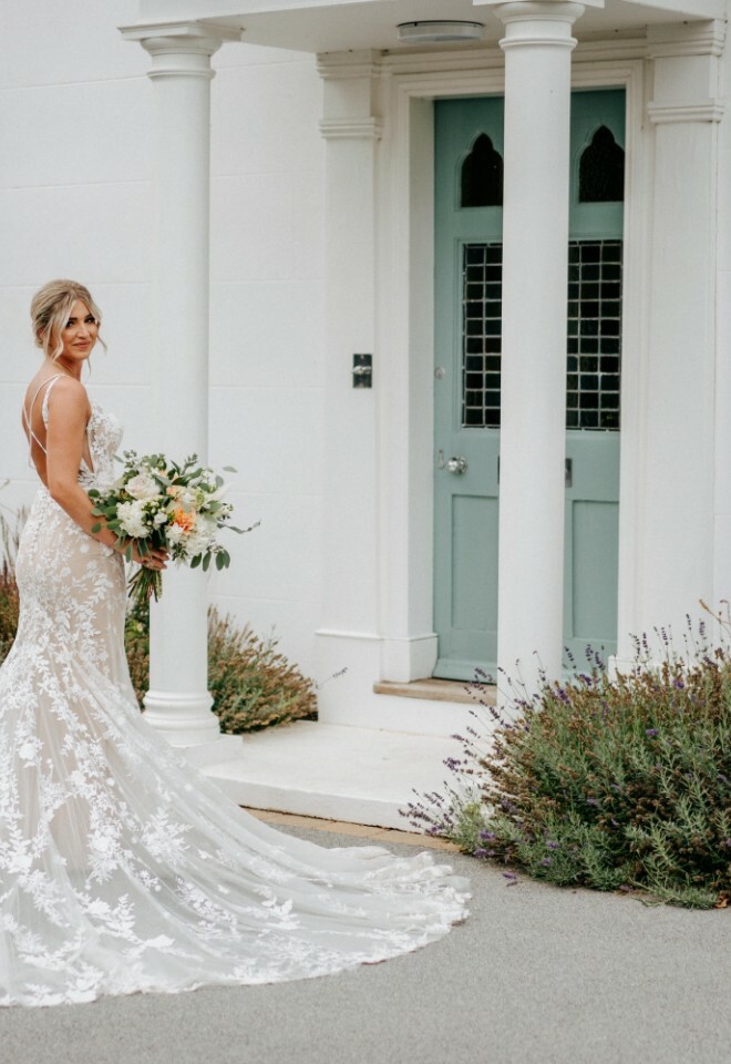 Bride outside the entrance to Vaulty Manor