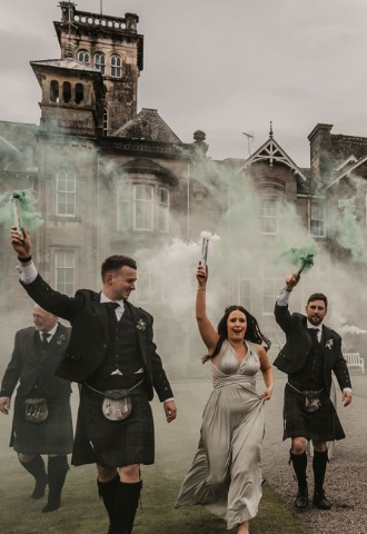 Wedding party with coloured smoke at Auchen Castle - a romantic castle wedding venue in Scotland