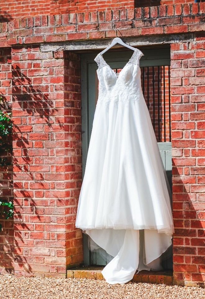 wedding dress hanging from wall