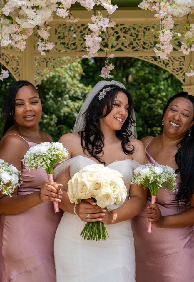 Wedding pink and white flower arch with pink bridemaid dresses burnham beeches hotel