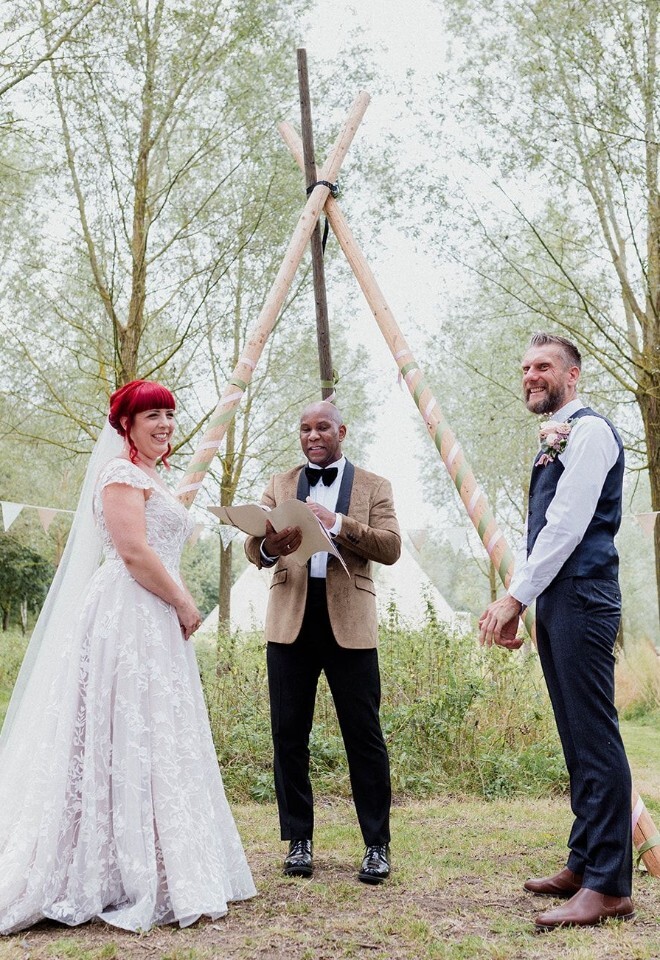 Dave Octave Celebrant conducting a ceremony in the woods with a happy laughing and smiling couple