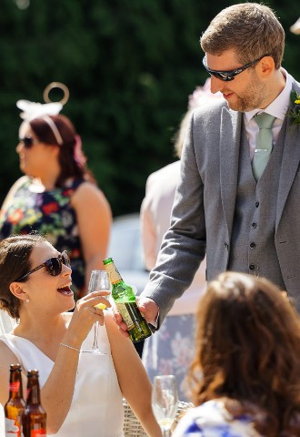 Bride and groom cheers at Coed Y Mwstwr Hotel, Bridgend