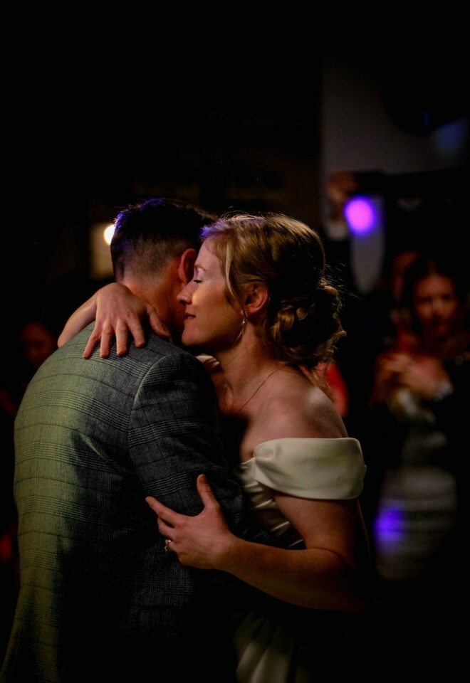 Newlyweds embracing on the dance floor during their first dance