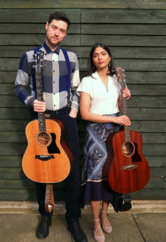 acoustic duo holding guitars