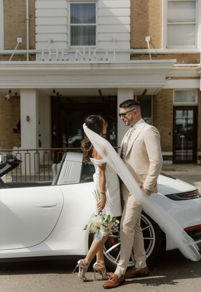 Bride & Groom stood by white porsche convertible car outside The Nici Hotel, Bournemouth, Dorset