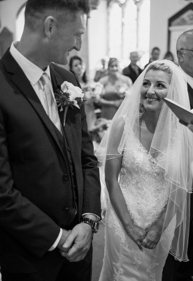 Bride and groom emotional wedding ceremony moment in timeless black and white