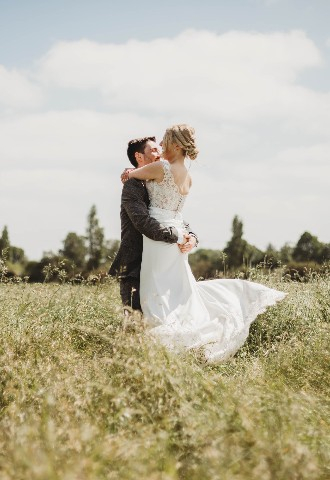 Wedding couple photo in the fields at Copdock Hall Suffolk