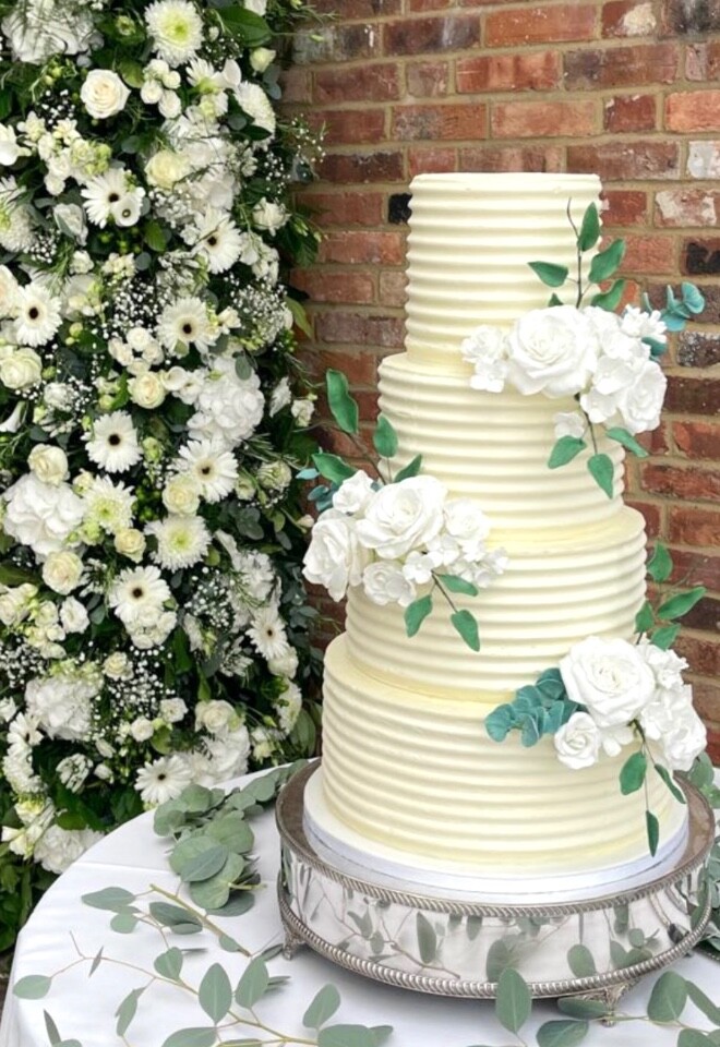 Textured buttercream cake with hand crafted sugar flowers and foliage