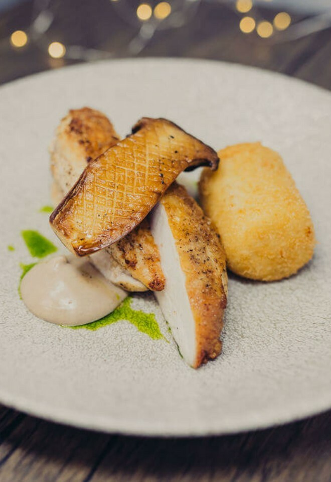 Roasted chicken breast, Eryngii king oyster mushroom, potato truffle croquette, fermented black garlic aioli, parsley oil