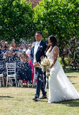 Outdoor ceremony with wedding couple at Hatfield House