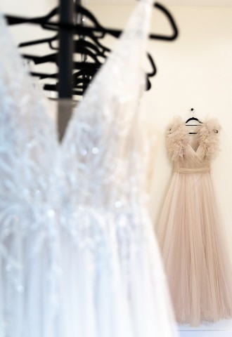 Two wedding dresses hanging up for bride to try on. Blush wedding dress.