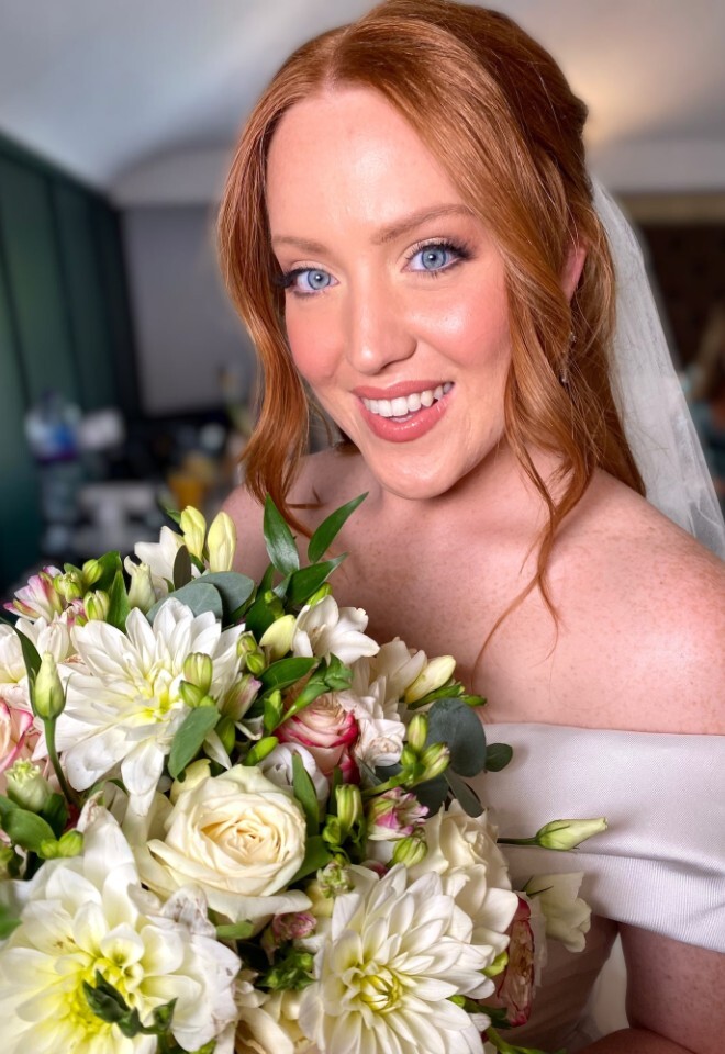 Soft glam glowy bridal makeup with a half up half down bridal hairstyle 