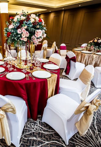 The Grand Princess Suite set for a wedding with bright red and gold theme