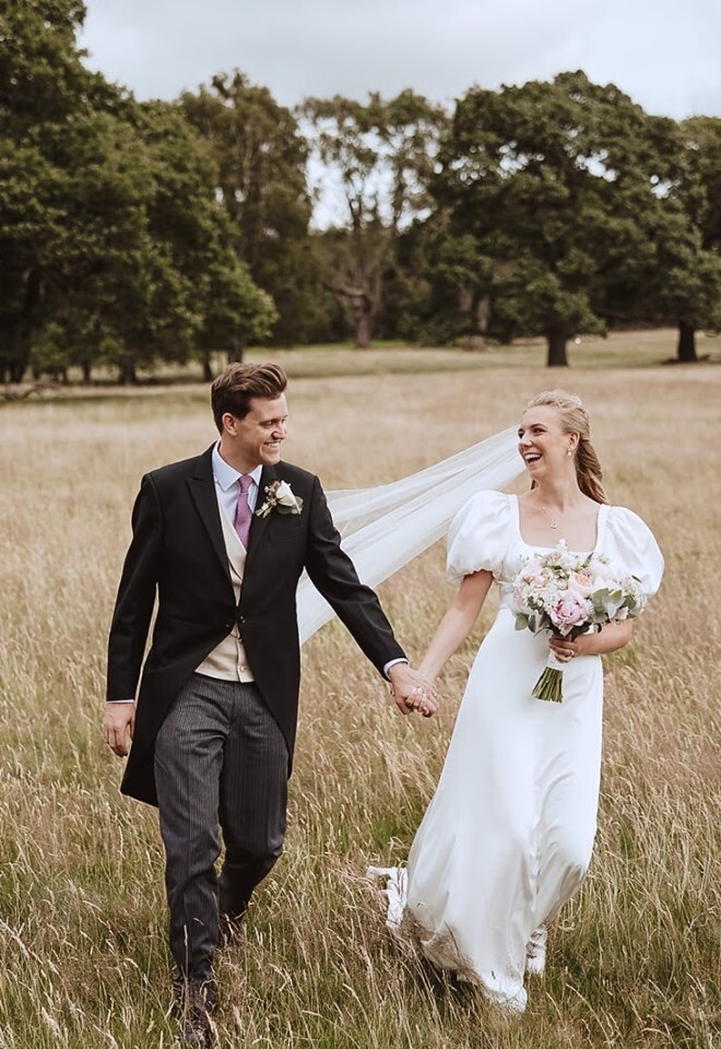 Bride and groom walking across the Chatsworth park at Heathy Lea Derbyshire wedding venue