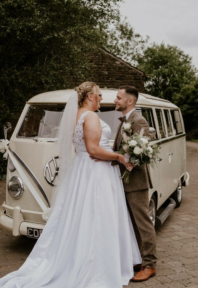 bride & groom stood in front of cream coloured vw camper van at The Stables Wedding Farm, Oldham