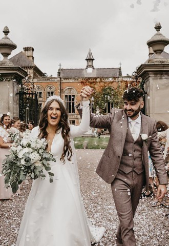 Bride and groom being showered in confetti at Soughton Hall, Flintshire
