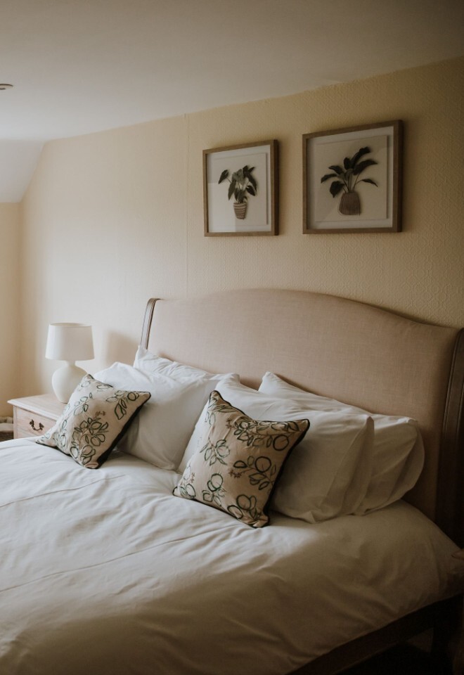 A cosy bedroom at an Oxfordshire barn house wedding venue