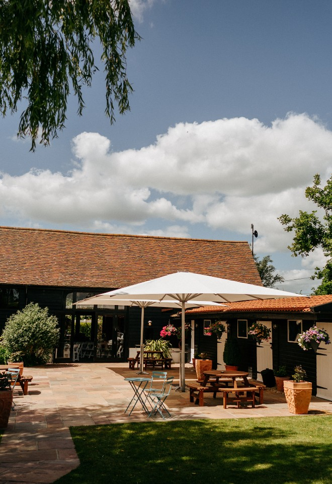 Exterior of the barn and gardens and High House wedding venue Essex