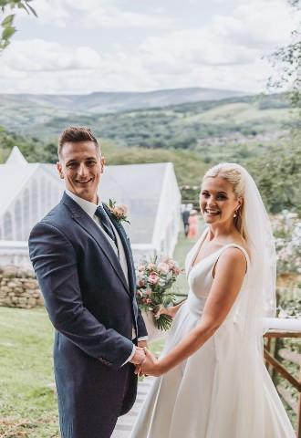 Bride & Groom wedding photo opportunity overlooking the Saddleworth hills from The Stables Wedding Farm in Oldham