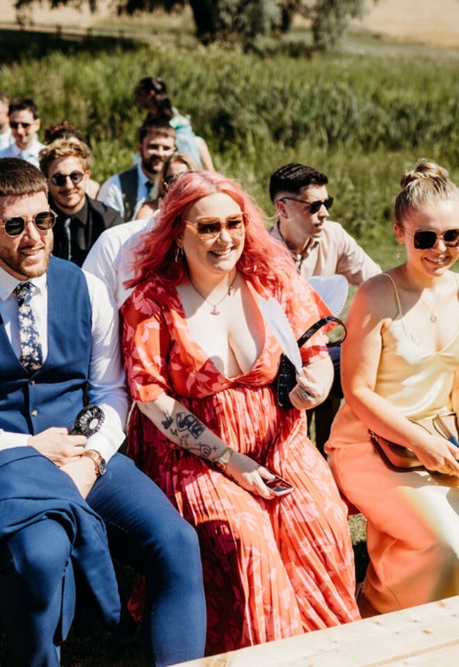 Smiling guests enjoying outdoor celebrant wedding ceremony