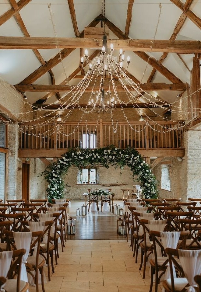 Indoor wedding ceremony inside Kingscote Barn