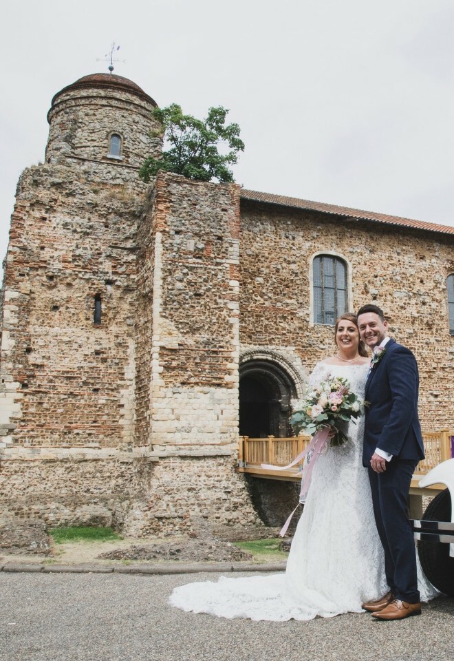 colchester castle bride & groom stood by wedding car, essex
