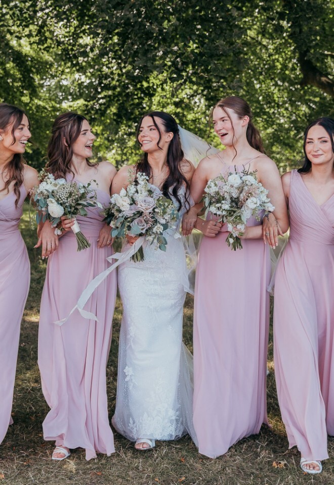 A bride and bridesmaids celebrating at a barn wedding venue in Oxfordshire