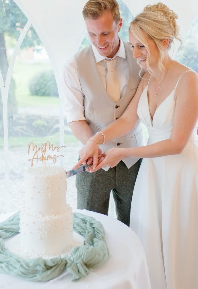 cutting the wedding cake, bride & groom, marquee receptions suffolk hungarian hall estate