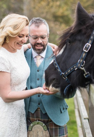 Wedding couple with horse in the grounds at Melville Castle - a castle wedding venue near Edinburgh