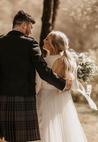 Bride & groom in the grounds at Auchen Castle - a romantic castle wedding venue in Scotland