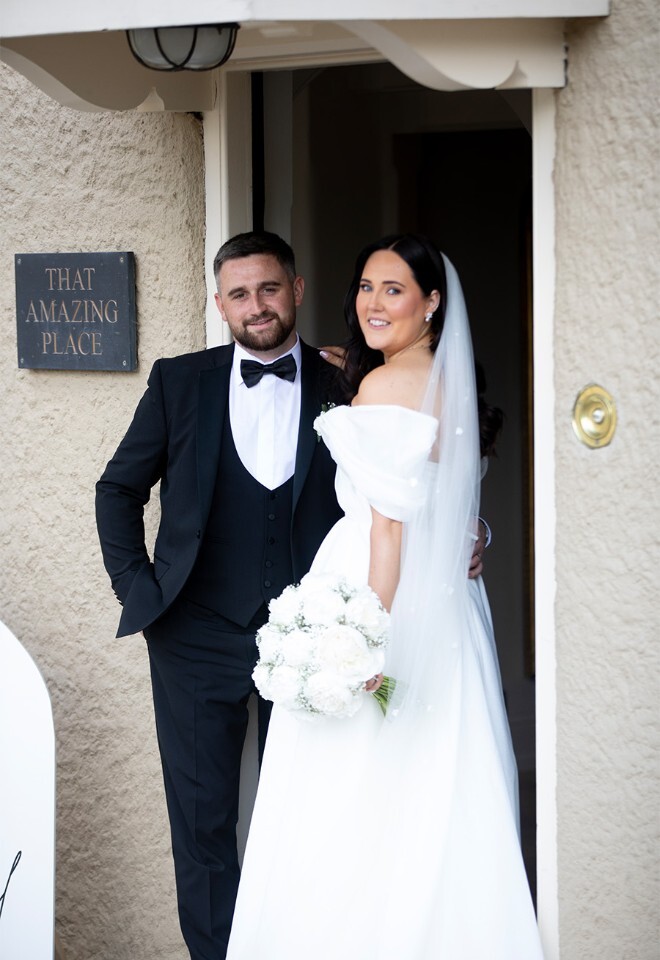 Bride and Groom by front door of That Amazing Place Essex Venue