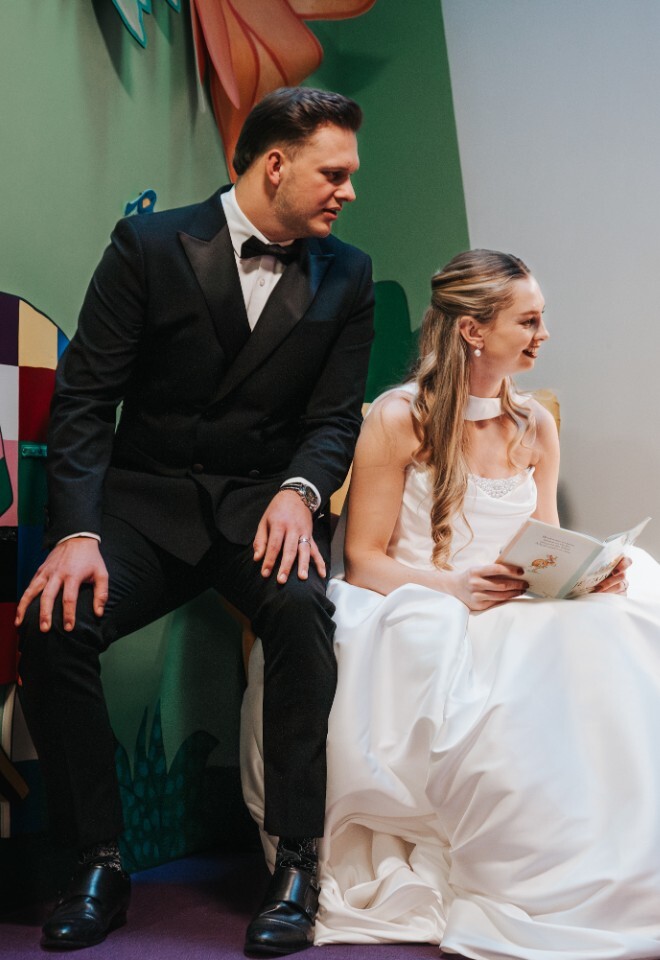 Bride and Groom in Family Friendly Wedding Venue in Small Worlds Reading Books