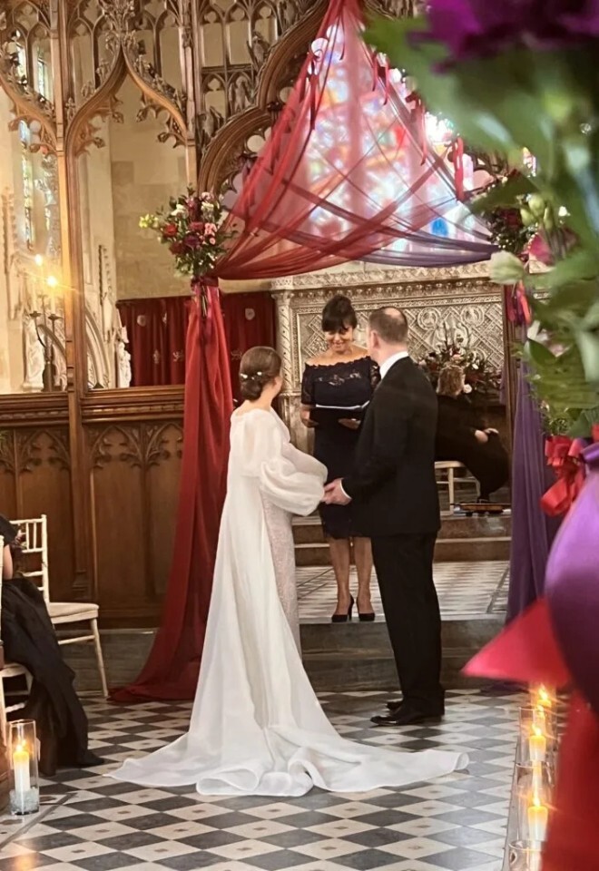 Bride and groom holding hands at the altar during a wedding ceremony with Your Forever After Celebrant based in Hertfordshire