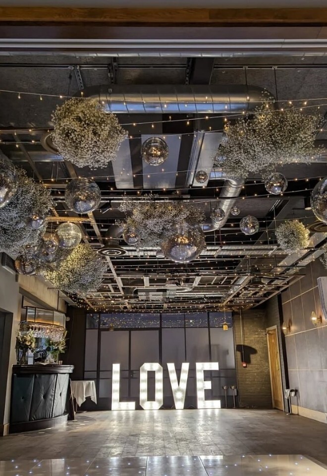 Dance floor, lights and LED love sign set up at The Royal Foresters, Berkshire wedding space.