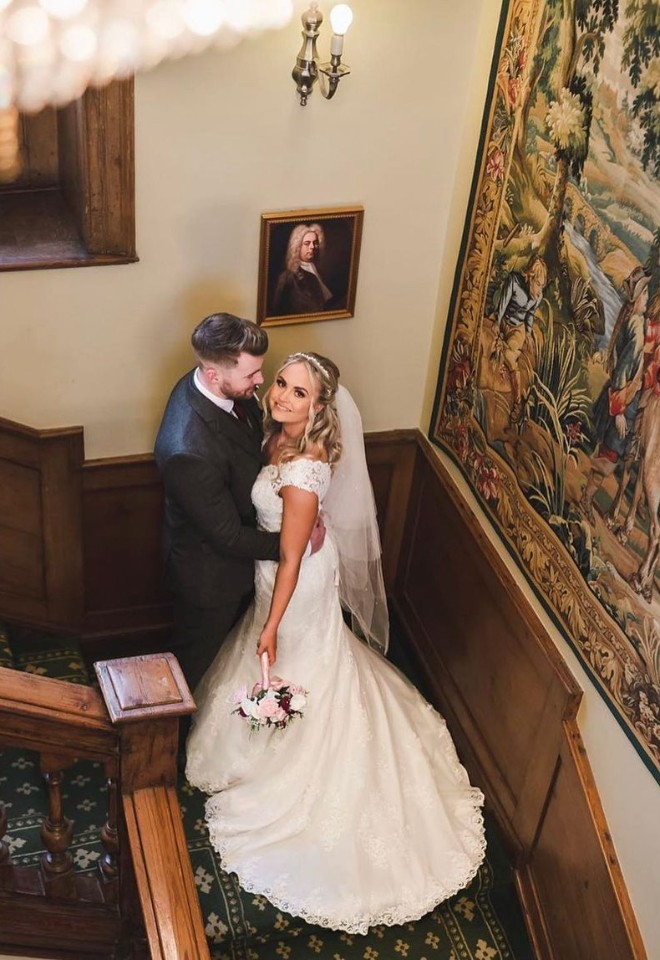 Bride and groom embracing the beautiful architecture on staircase inside of Hockwold Hall wedding venue in Norfolk