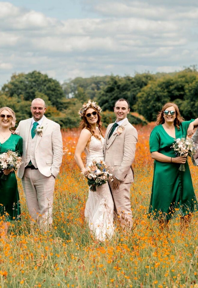 Wed couple with bridal party in the field