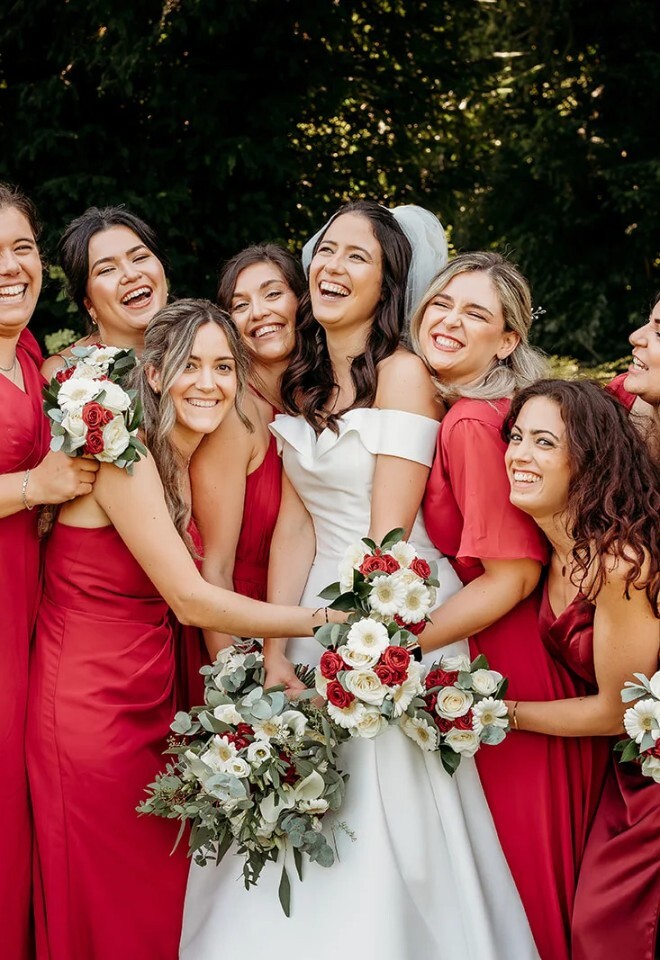 red & white, bride & bridemaids holding red and white bouquets from Willow & Bloom