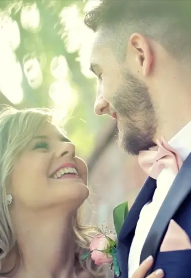 Image of wedding couple posing against garden wall filmed by CKS productions in Berkshire