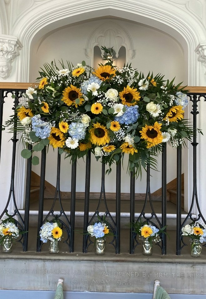 sunflower and blue flower banister display by hire heaven