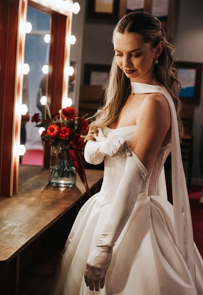 Bride Getting Ready in front of Festoon Lights and Mirror